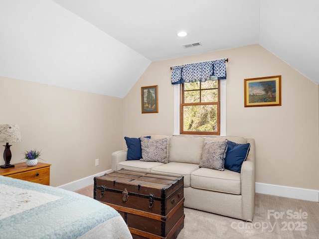 bedroom featuring lofted ceiling and light carpet