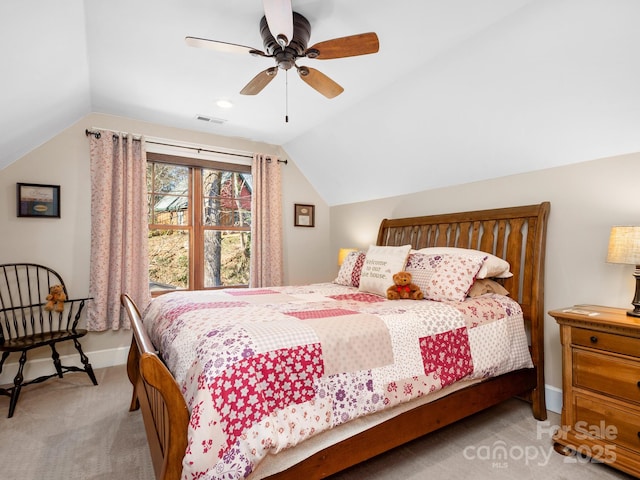 bedroom with light carpet, vaulted ceiling, and ceiling fan