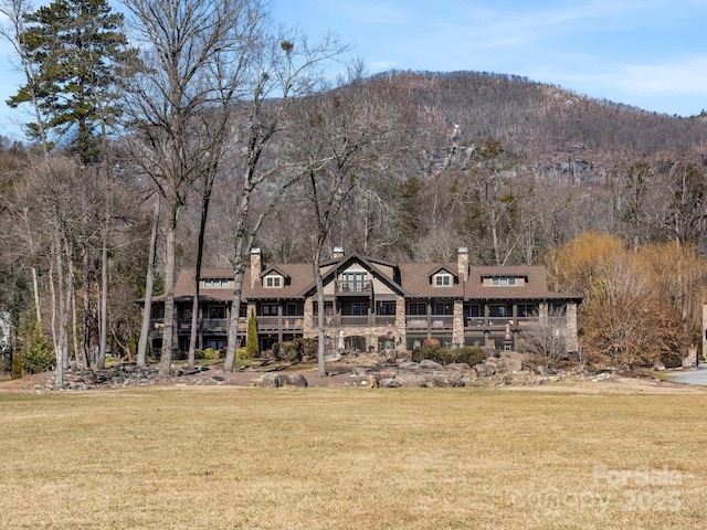 exterior space with a mountain view and a lawn