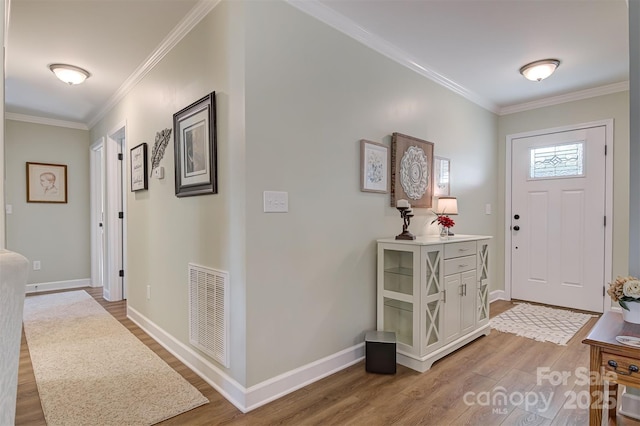 entryway with crown molding and hardwood / wood-style flooring