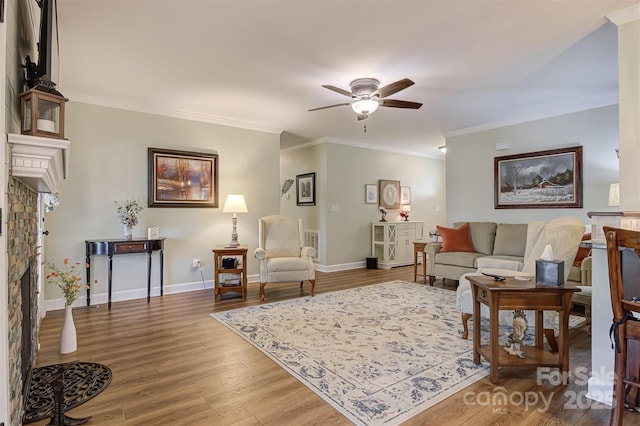 living room featuring hardwood / wood-style flooring, ornamental molding, and ceiling fan