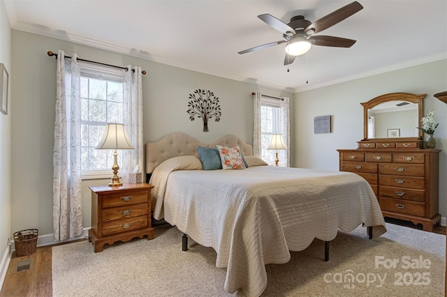 bedroom featuring crown molding, ceiling fan, and light wood-type flooring