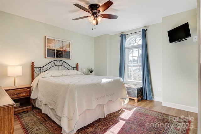 bedroom featuring wood-type flooring and ceiling fan