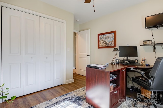 office area with dark hardwood / wood-style flooring and ceiling fan