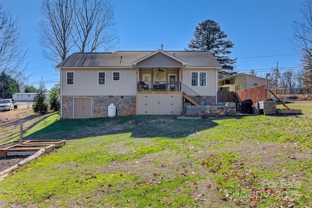 back of property featuring a lawn and ceiling fan