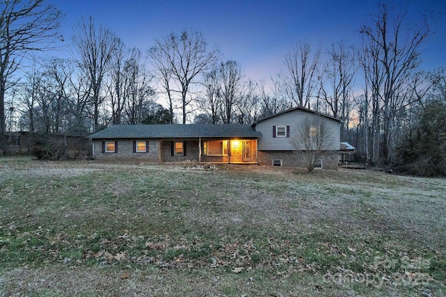 tri-level home featuring a lawn