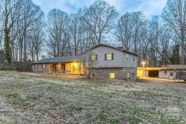 back of house with a lawn