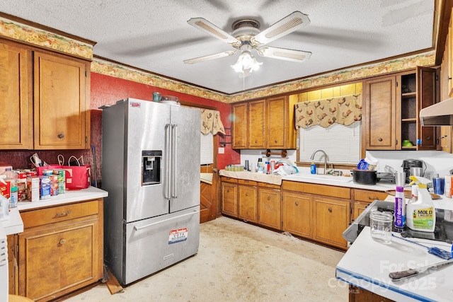 kitchen with high end fridge, sink, a textured ceiling, and ceiling fan