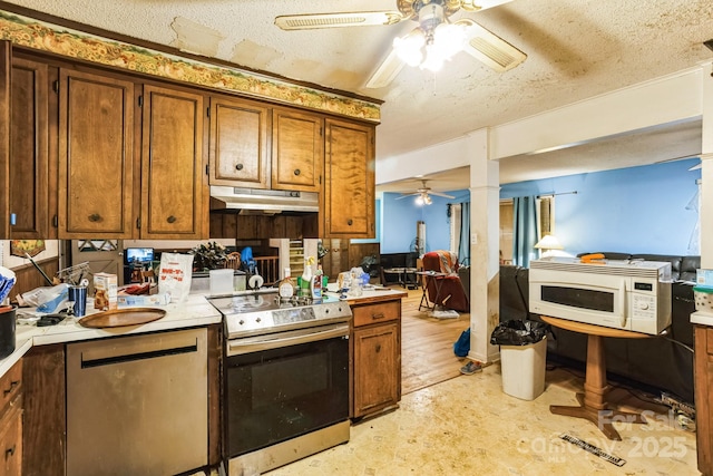 kitchen featuring stainless steel range with electric stovetop, ceiling fan, and a textured ceiling