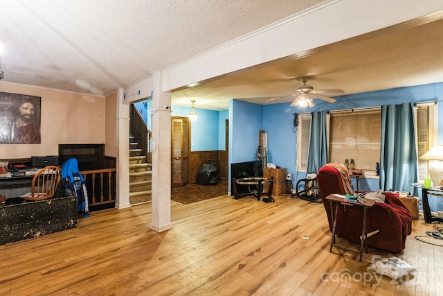 interior space featuring wood-type flooring, ceiling fan, and a textured ceiling