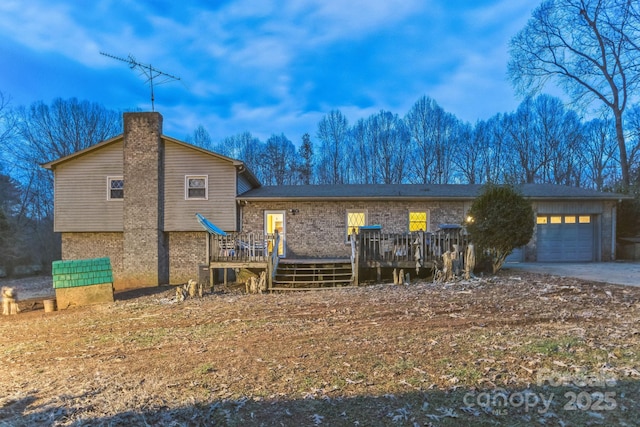 view of front of house with a wooden deck and a garage