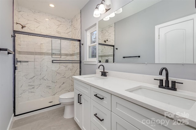 bathroom featuring walk in shower, vanity, and toilet