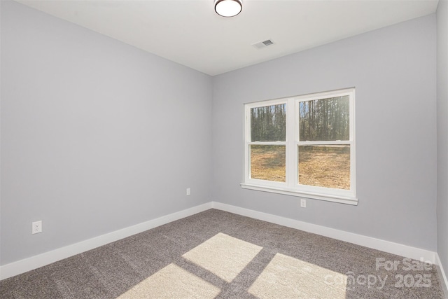empty room featuring visible vents, carpet floors, and baseboards