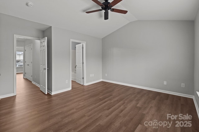 unfurnished bedroom featuring vaulted ceiling, dark hardwood / wood-style floors, and ceiling fan