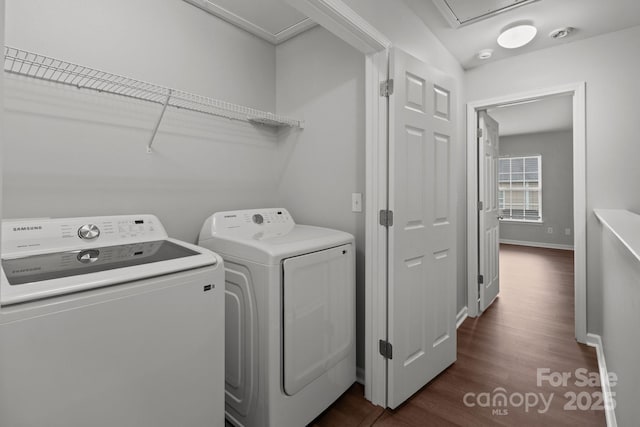 washroom featuring washer and clothes dryer and dark hardwood / wood-style floors