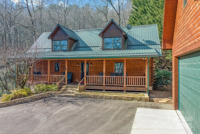 log home featuring a porch