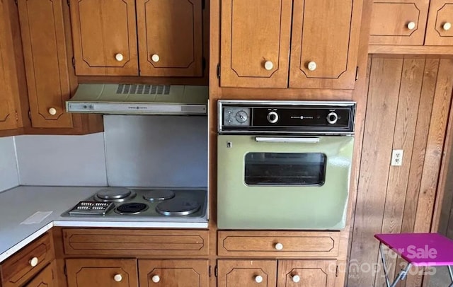 kitchen featuring wall oven, cooktop, and extractor fan