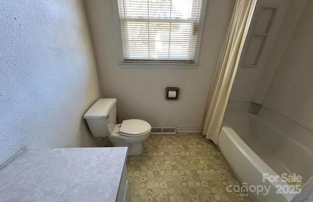 full bathroom with vanity, shower / bath combo, and toilet