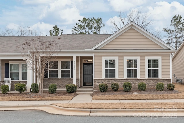 view of front of property featuring brick siding and covered porch