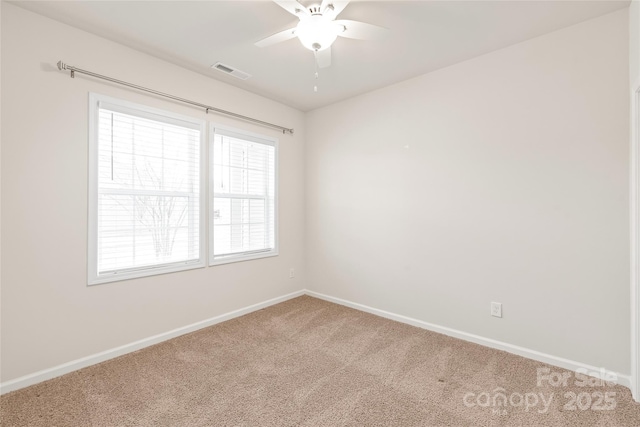 carpeted empty room with ceiling fan, baseboards, and visible vents