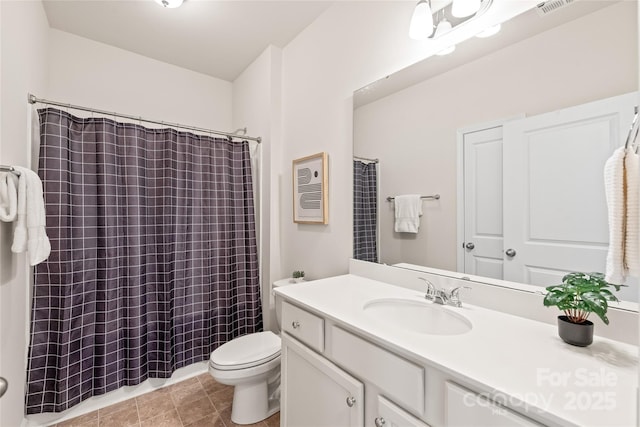 bathroom featuring tile patterned flooring, toilet, vanity, and a shower with shower curtain