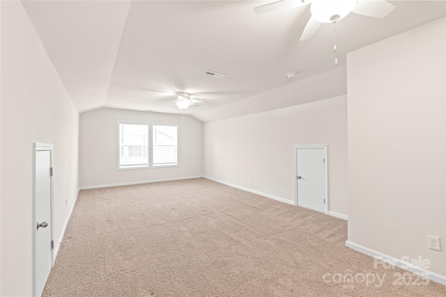 bonus room with vaulted ceiling, visible vents, light carpet, baseboards, and ceiling fan