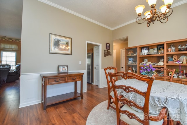 dining room with ornamental molding, dark hardwood / wood-style flooring, and a chandelier