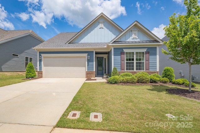 view of front of house with a garage and a front lawn