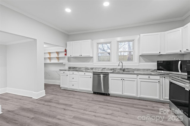 kitchen with sink, white cabinets, light stone counters, stainless steel appliances, and light hardwood / wood-style flooring