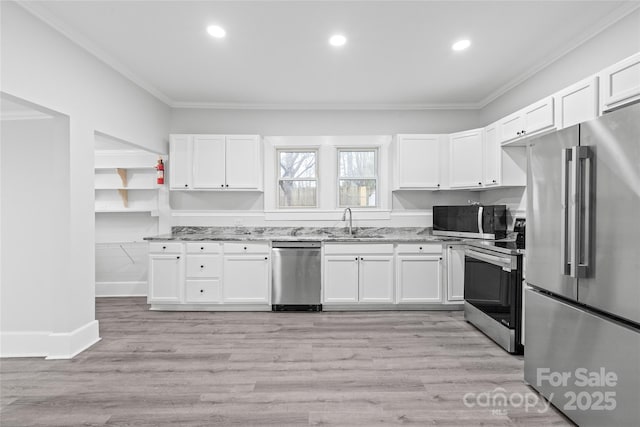 kitchen with white cabinetry, light stone countertops, and stainless steel appliances