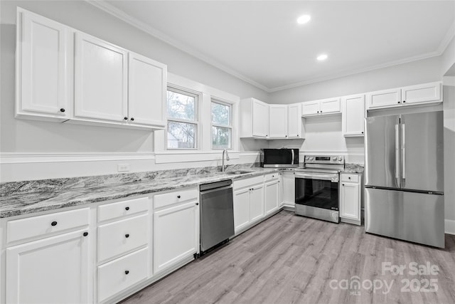 kitchen with stainless steel appliances, light stone countertops, sink, and white cabinets