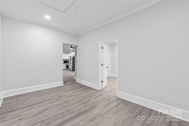 unfurnished room featuring ornamental molding, ceiling fan, and light hardwood / wood-style flooring