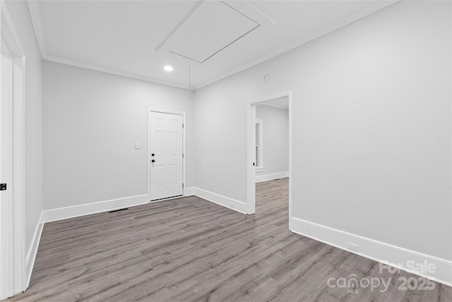 empty room featuring hardwood / wood-style floors and ornamental molding