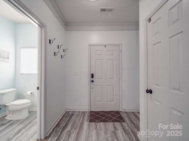 interior space featuring hardwood / wood-style flooring and ornamental molding