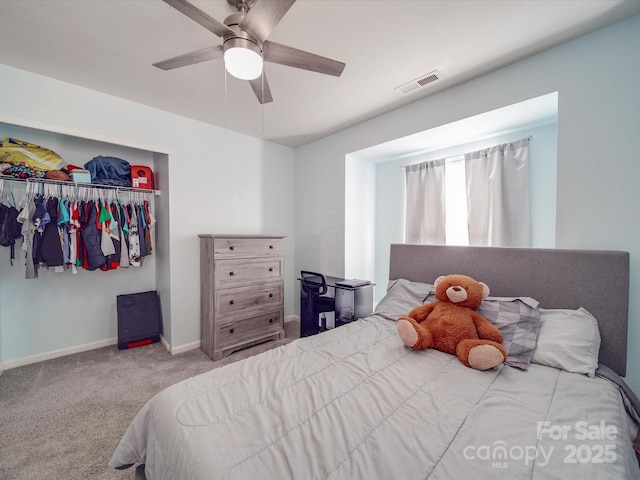 carpeted bedroom with ceiling fan and a closet