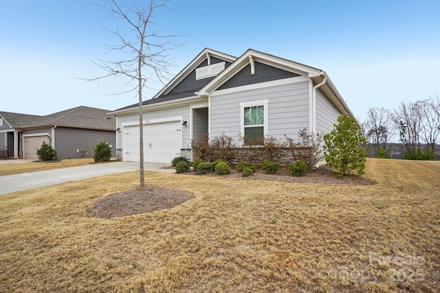 craftsman inspired home with a garage and a front lawn