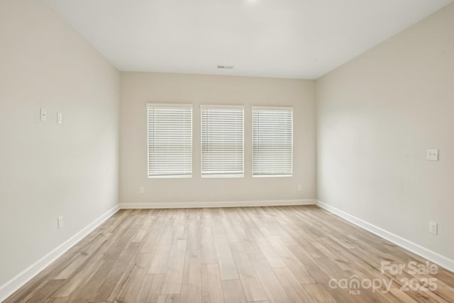 spare room with light hardwood / wood-style floors