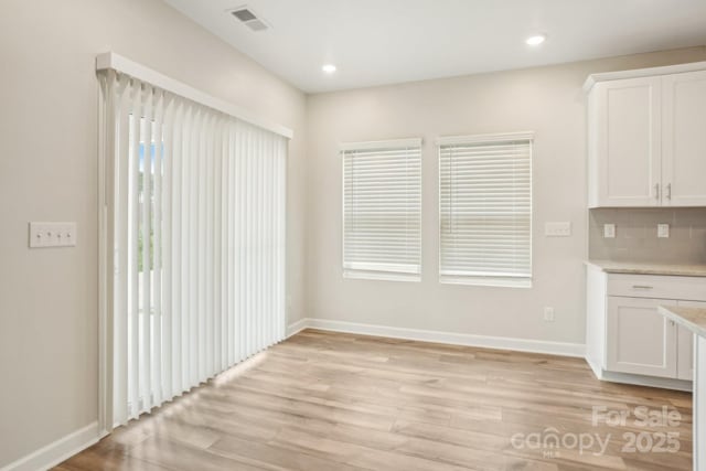 unfurnished dining area featuring light hardwood / wood-style flooring and a healthy amount of sunlight