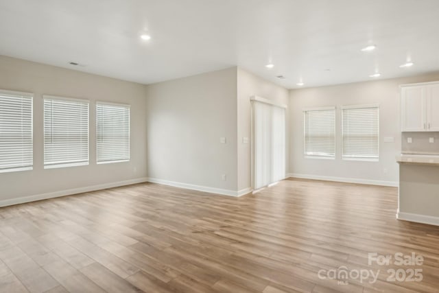 unfurnished living room with light wood-type flooring