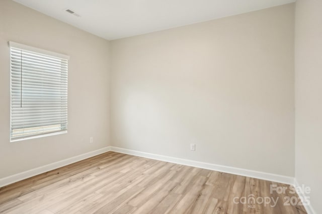 spare room with light wood-type flooring