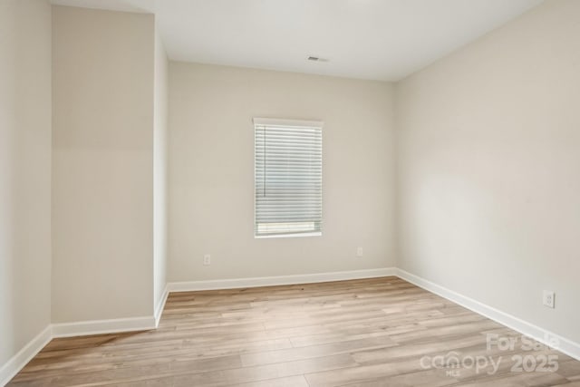 spare room with light hardwood / wood-style floors