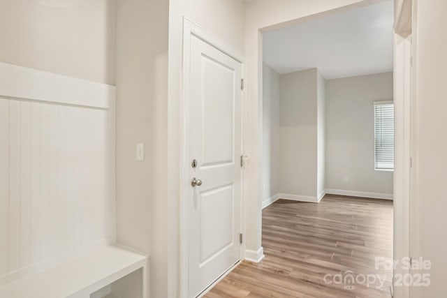 corridor with light hardwood / wood-style floors