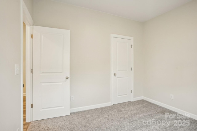 unfurnished bedroom with light colored carpet