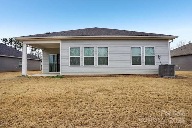 back of property with a yard, a patio area, and central air condition unit