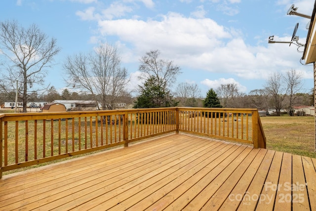 wooden deck featuring a yard