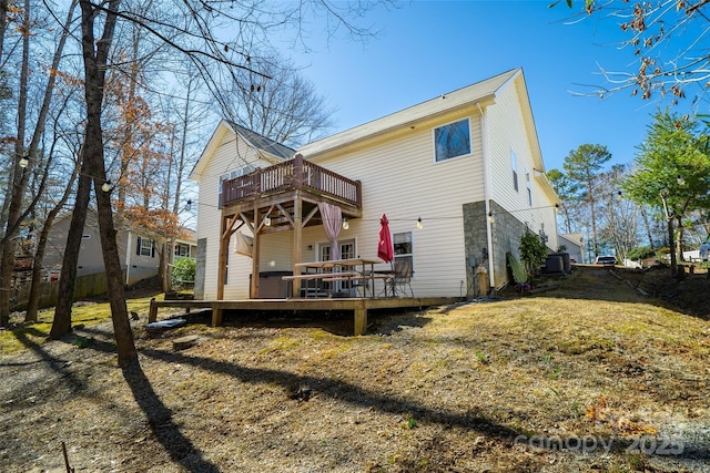 back of property featuring a yard and a wooden deck