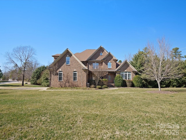 view of front of house with brick siding and a front yard