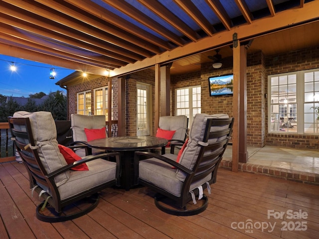 wooden deck featuring outdoor dining area