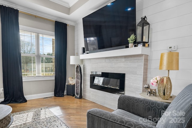 living room with crown molding and wood-type flooring