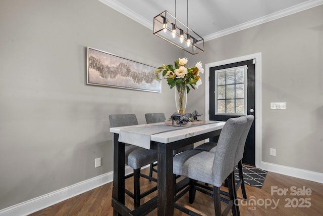 dining room featuring crown molding and dark wood-type flooring